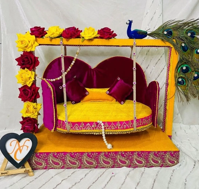 Beautifully Yellow And Pink Colour wooden swing (jhula) for Laddu Gopal Ji, adorned with peacock feathers